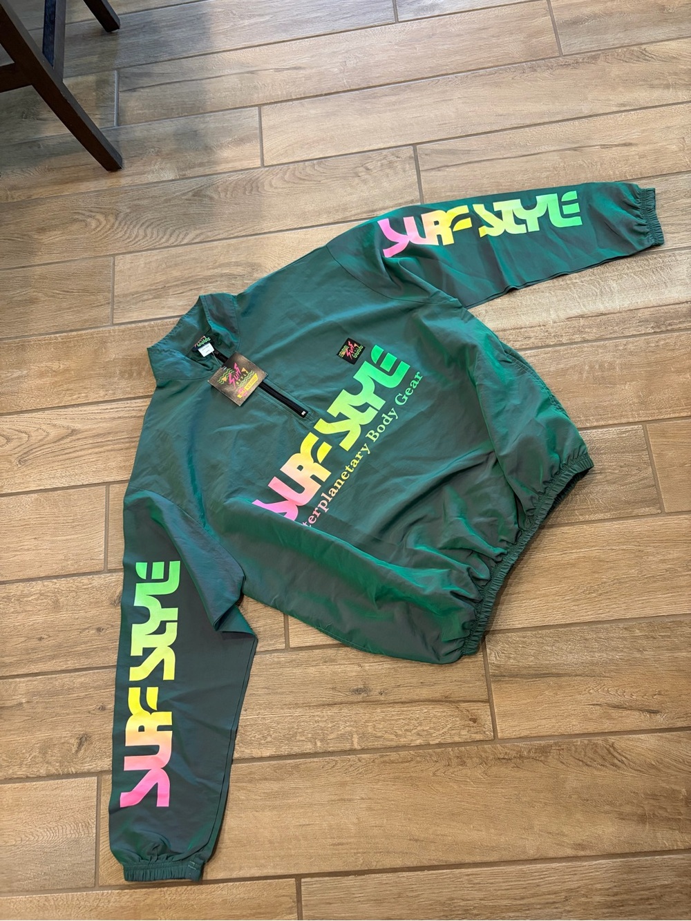 Surf Style windbreaker iridescent green with black zipper and neon logo tag